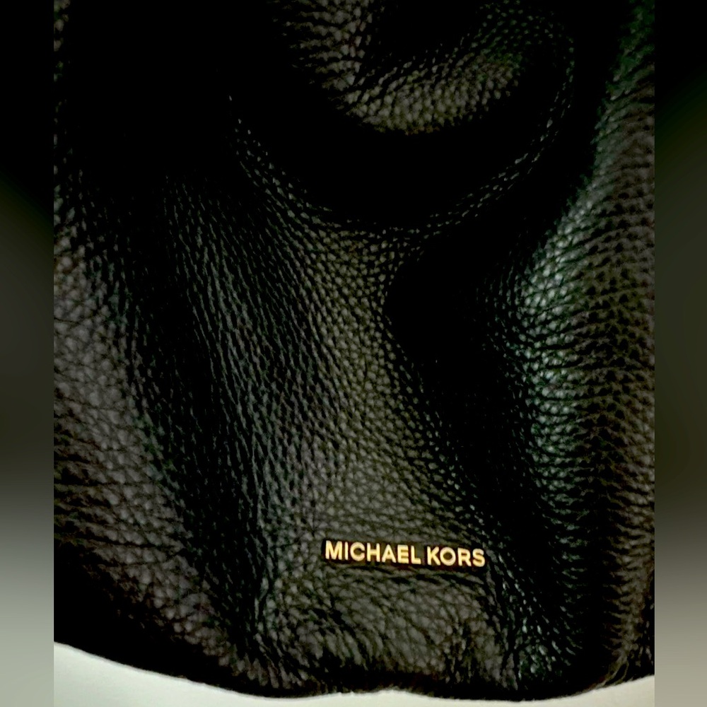 Michael Kors jet black pebbled leather crossbody bag with gold hardware.
